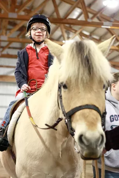 Grace Carney enjoys riding high at Free Rein Therapeutic Riding. - AUSTIN ODELL