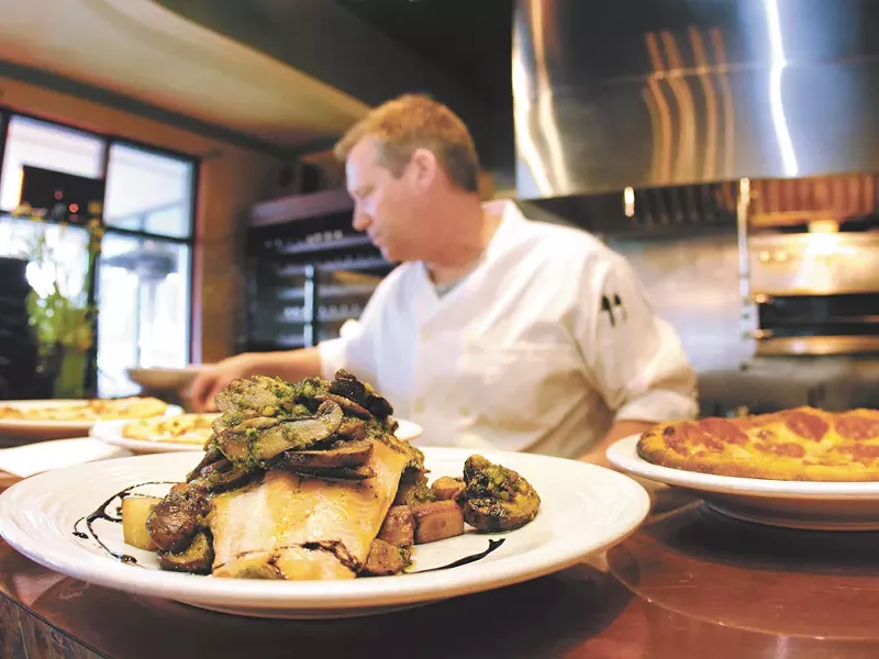 Halibut with potatoes and mushrooms in the foreground. - JOE KONEK