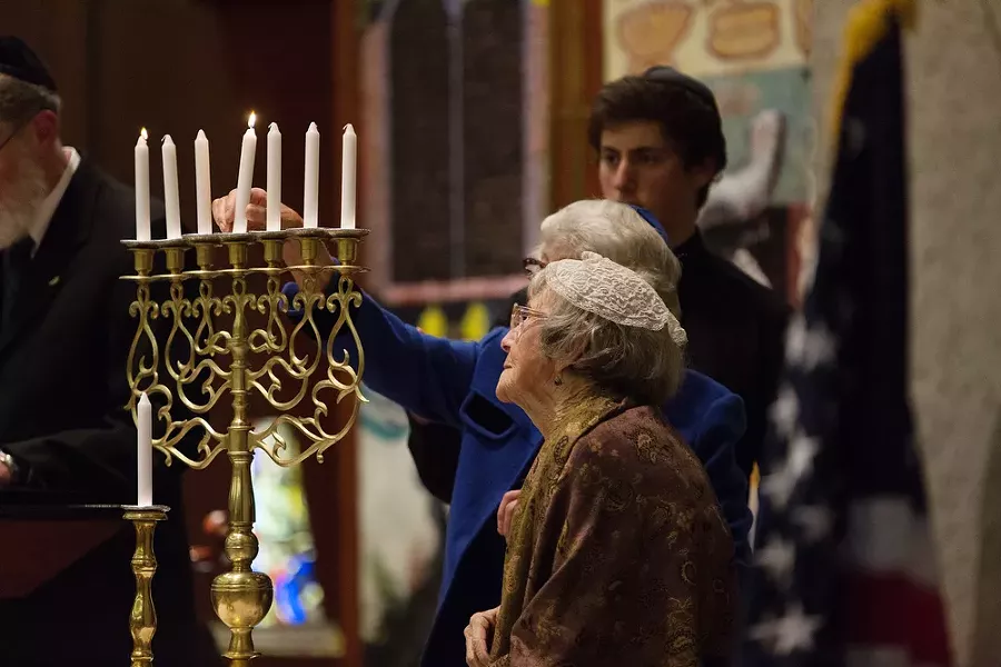 Holocaust survivors Irene Boehm, front, and Carla Peperzak light a candle. - YOUNG KWAK