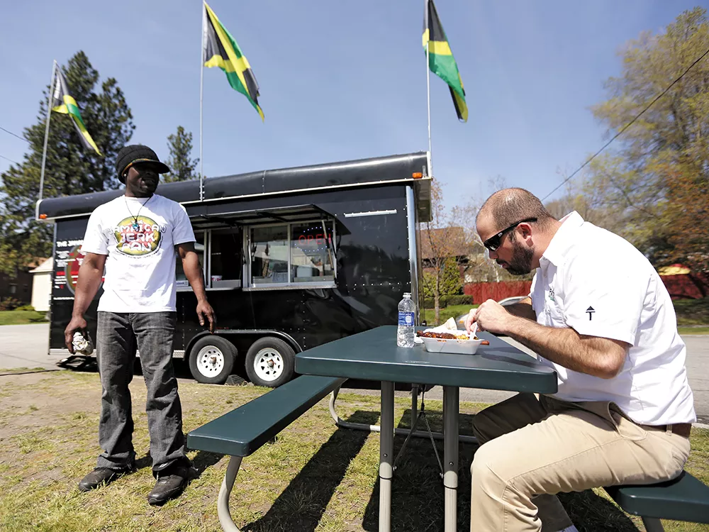 Jamaican Jerk Pan co-owner Roian Doctor with his food truck, which was almost towed by the city last week. - YOUNG KWAK