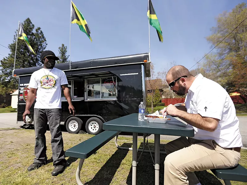 Jamaican Jerk Pan co-owner Roian Doctor with his food truck, which was almost towed by the city last week. - YOUNG KWAK