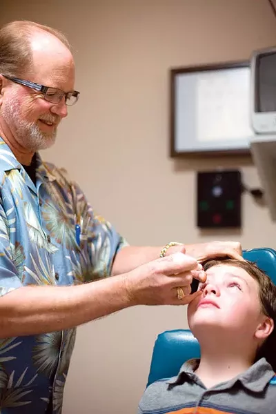 Jason Stone gets an eye exam by Dr. Jeffrey Snow. - RACHEL SCHELL