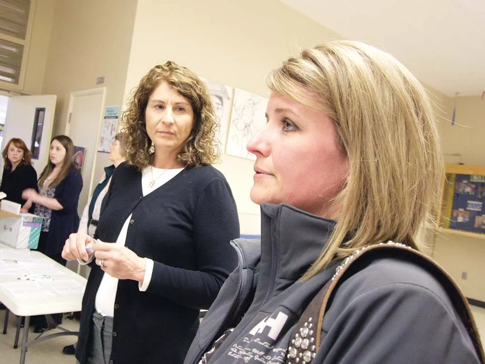 Jefferson Elementary School teacher Gail Madsen, right, talks about layoffs, with Human Resources Specialist Diana Shelton. - YOUNG KWAK