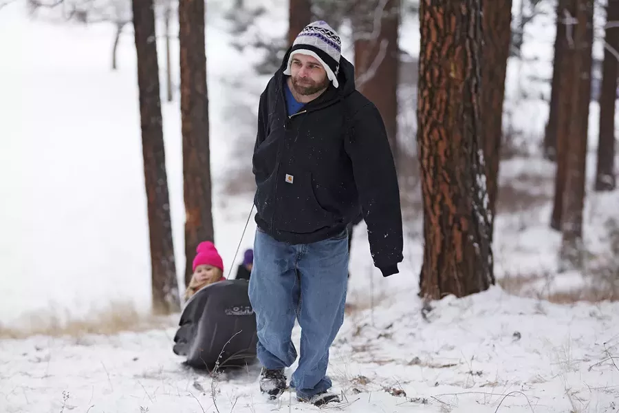 Jeremy Swanson pulls his daughter Saveena, 5, on a sled at Underhill Park. - YOUNG KWAK