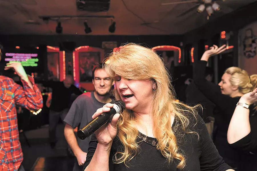 JJ White sings karaoke at Studio K Bar & Grill on the South Hill, which recently moved to a new location on Regal. In 2008, the business was sued by ASCAP. - STEVEN SCHLANGE