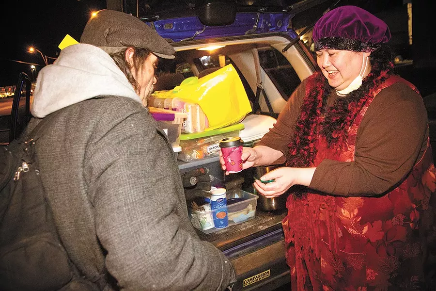 Joan Medina hands out coffee and food to Spokane's homeless population. - JENNIFER DEBARROS