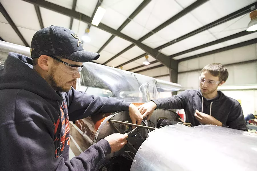 Josh Newburg, left, and Nick Bell install solenoids. As a quarter of Boeing machinists prepare to retire, Washington has rushed to train new aerospace employees through conduits like Spokane Community College's aviation program. - YOUNG KWAK