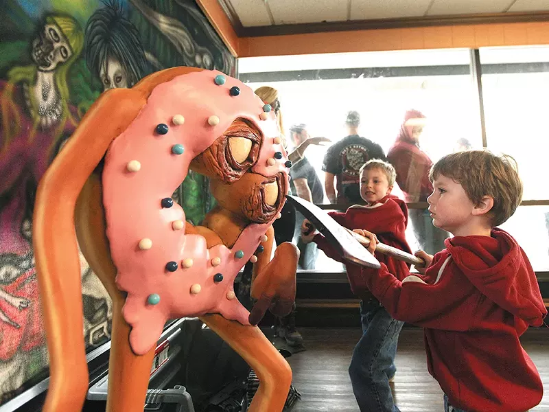 J.T. Sutherland, right, and his brother, Noah, take the ax to a donut zombie. - YOUNG KWAK