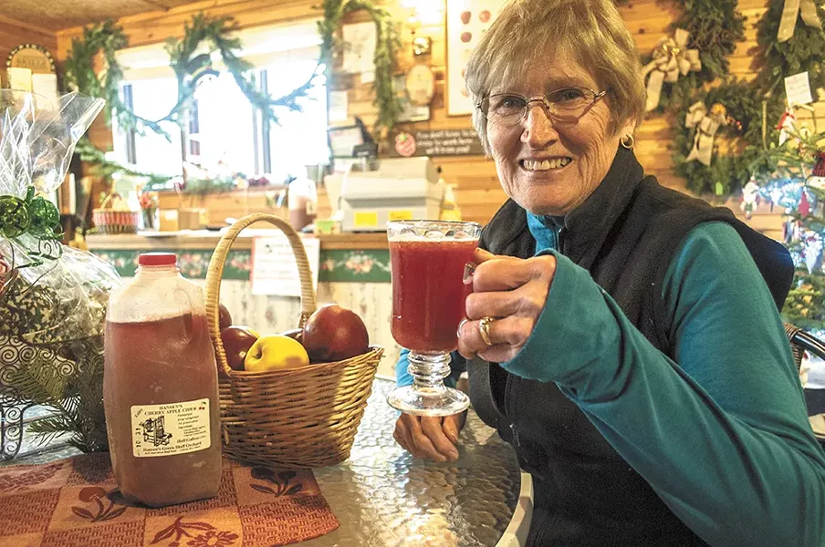 Karen Hansen with a glass of her family's cherry apple cider at Hansen's Green Bluff Orchard. - SARAH WURTZ