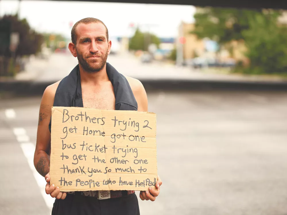 Kevin, who didn\'t give his last name, panhandles at Fifth Avenue and Walnut Street in Spokane. He says he\'s trying to get bus tickets for him and his brother to go home to California - YOUNG KWAK