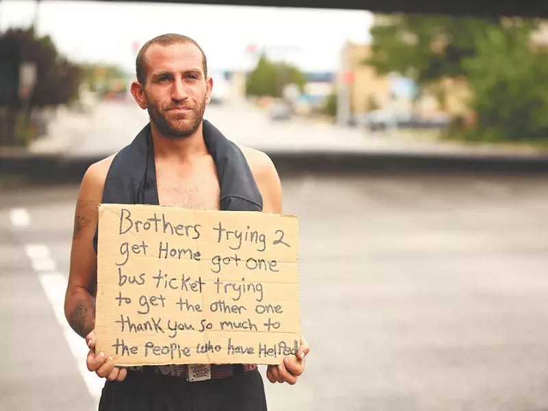 Kevin, who didn\'t give his last name, panhandles at Fifth Avenue and Walnut Street in Spokane. He says he\'s trying to get bus tickets for him and his brother to go home to California - YOUNG KWAK