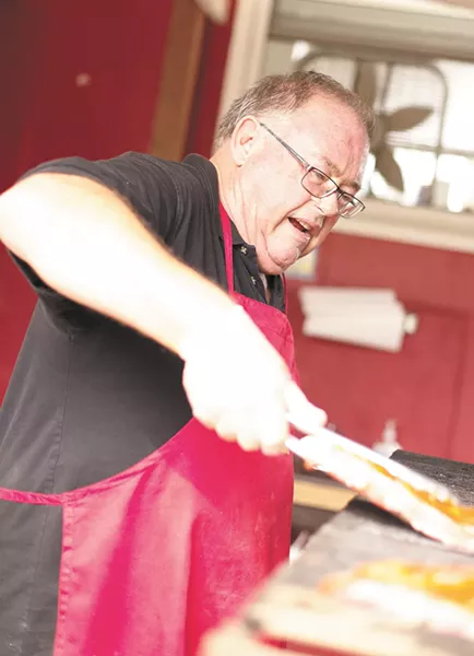 LeRoy Payne prepares ribs at his new Uncle LeRoy's BBQ location - YOUNG KWAK