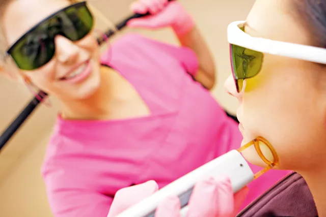 Mandy Shaw (left) and Elizabeth Shaw demonstrate a laser procedure at Louisville Laser in Spokane. - YOUNG KWAK