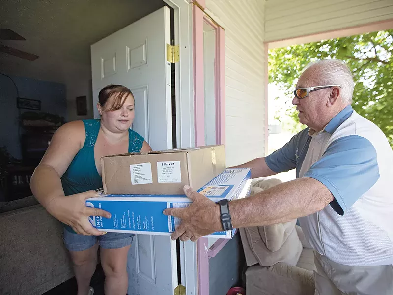 Meals on Wheels volunteer Dick Main delivers fans and food last week. - YOUNG KWAK