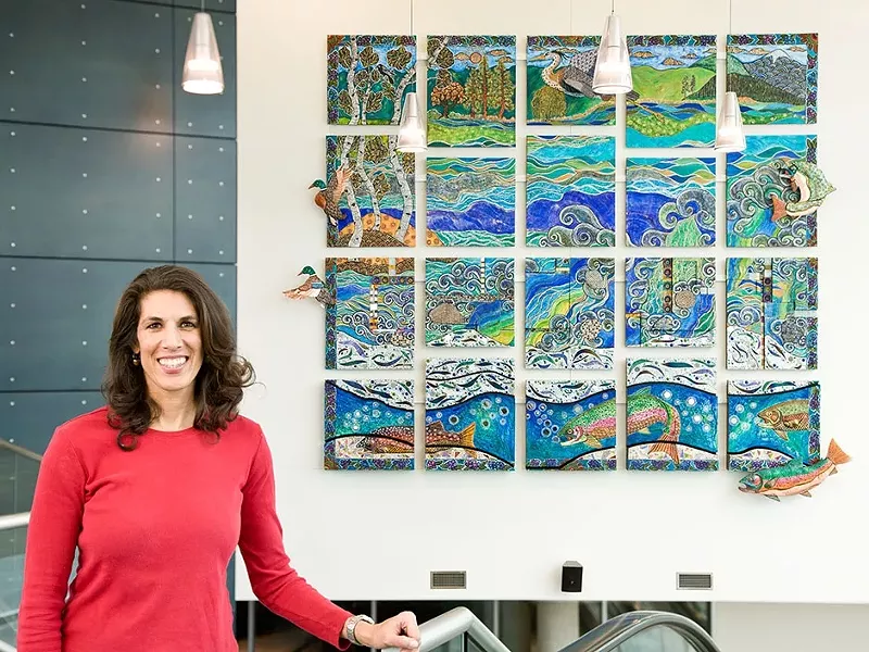Melissa Cole in front of her \"River Dance,\" now on display at the JACC.