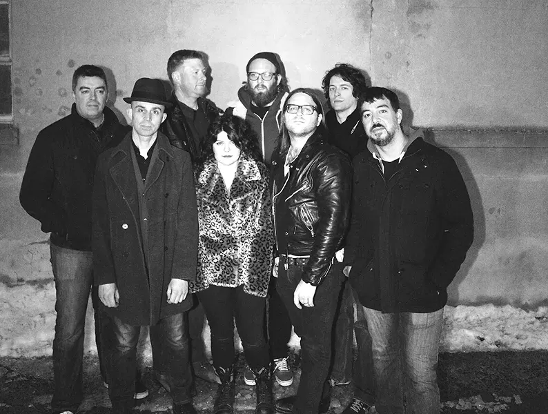 Mike V. , in the back with the beard, stands surrounded by one of the ever-changing Everymen lineups.