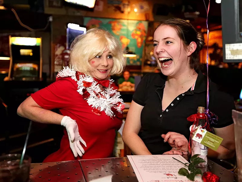 Nancy Erchul, left, owner of Nancy\'s Novelty Grams, delivers a singing telegram for Sarah Burgess at Cricket\'s Steakhouse. - YOUNG KWAK