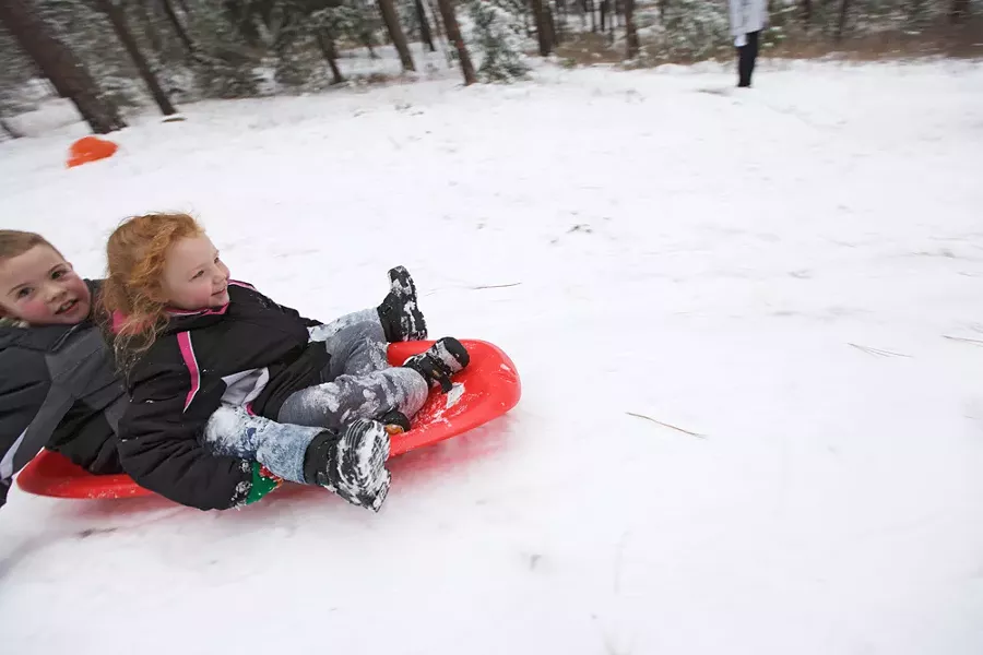 Nine-year-old Samuel Bakken, left, and his 7-year-old sister, Emily, sled at Underhill Park. - YOUNG KWAK