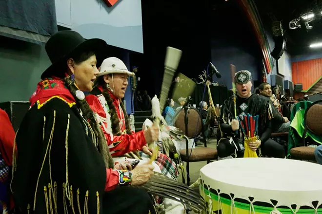 Nora RedFox BrownEagle, left, of the Blackfeet Nation, Dave BrownEagle, center, of the Spokane Tribe and Ho-Chunk Nation, and Robert Wynecoop, of the Spokane Tribe, drum. - YOUNG KWAK