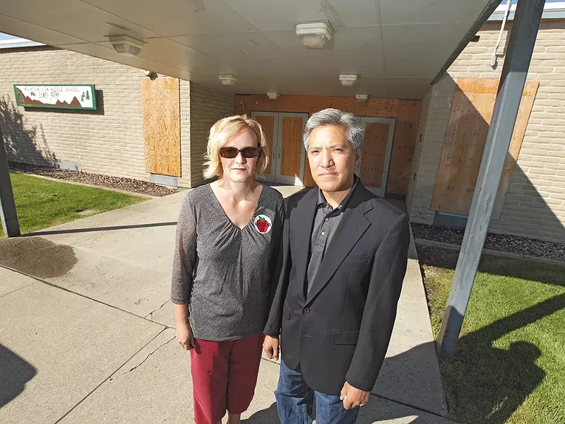 Parents Mindy Stewart and her husband, Dan, outside a boarded-up Mountain View Middle School. - YOUNG KWAK