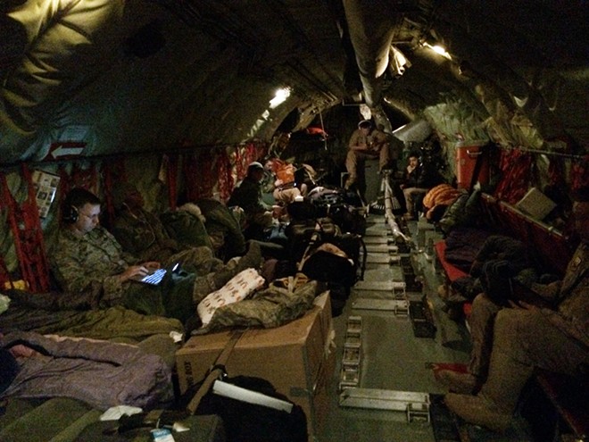 Passengers rest in a KC-135 flying from Fairchild Air Force Base. - YOUNG KWAK
