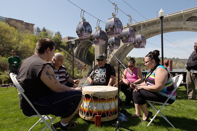Spokane tribal members (left to right) Robert Corral, Paul Corral, Gabby Corral, Lucille Mathias and Leona Stanger play a drum. - YOUNG KWAK