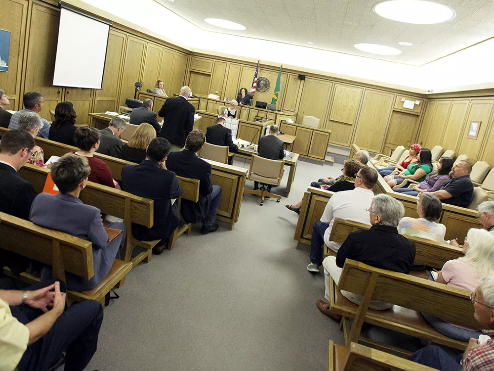 Politicians, business lobbyists and citizen activists filled a courtroom last week to hear arguments over two local initiatives. - YOUNG KWAK