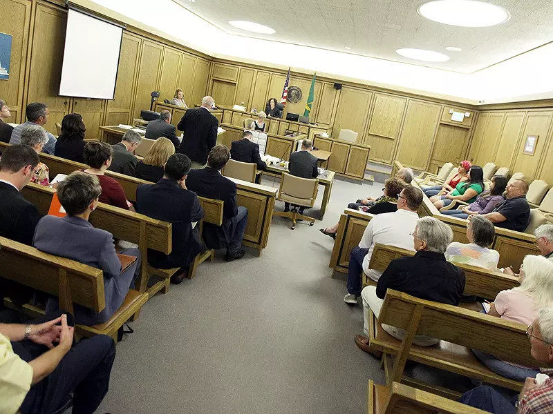 Politicians, business lobbyists and citizen activists filled a courtroom last week to hear arguments over two local initiatives. - YOUNG KWAK