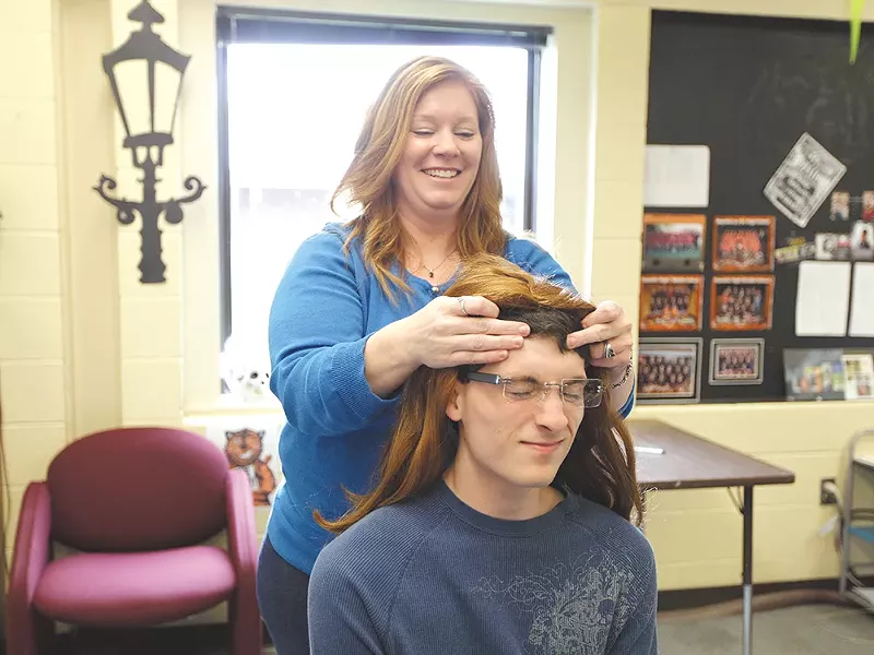 Republic High School teacher Liz Bremner dolls up Tyler Weyer, who played Sarah Palin for a school event. - YOUNG KWAK