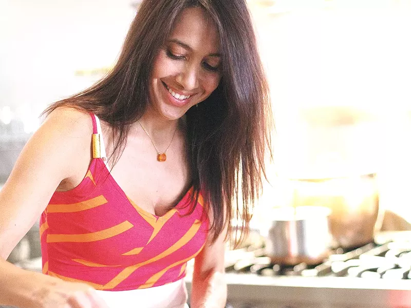 Sara Balcazar-Greene works the wok in the kitchen located inside The Purple Turtle. - YOUNG KWAK