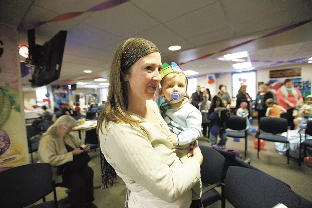 Sarah Jorgensen celebrates with her newly adopted son, Lørn, at the Spokane County Courthouse last week. - YOUNG KWAK