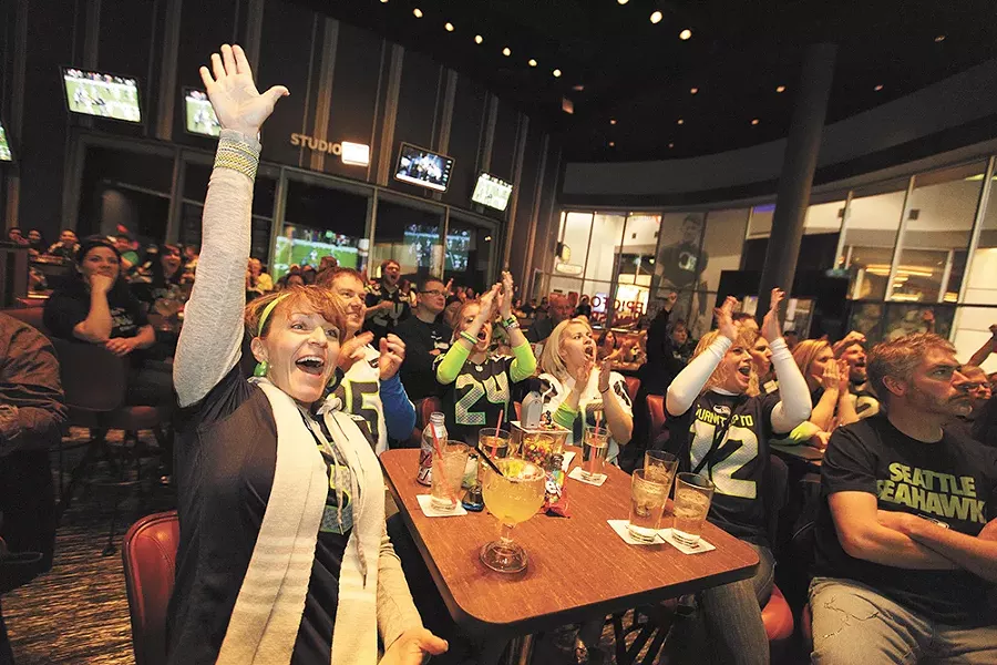 Seahawks fan Tammy Duenas celebrates the NFC Football Championship win against San Francisco at Northern Quest Resort & Casino's EPIC bar. - YOUNG KWAK