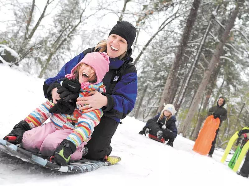 Shelli Montilla and her daughter, Emma, sled at Manito Park on Monday. - CHRISTIAN WILSON
