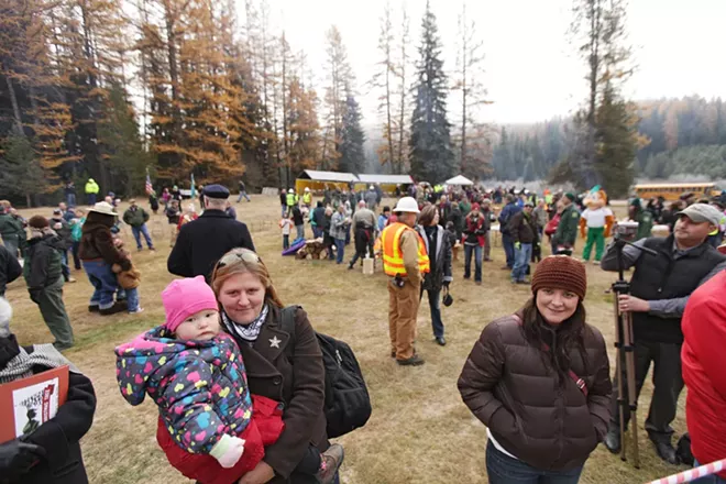 Sonia Wirth, left, holding her 20-month-old daughter Sadie, and Stephanie Wirth wait for the tree to be cut. - YOUNG KWAK