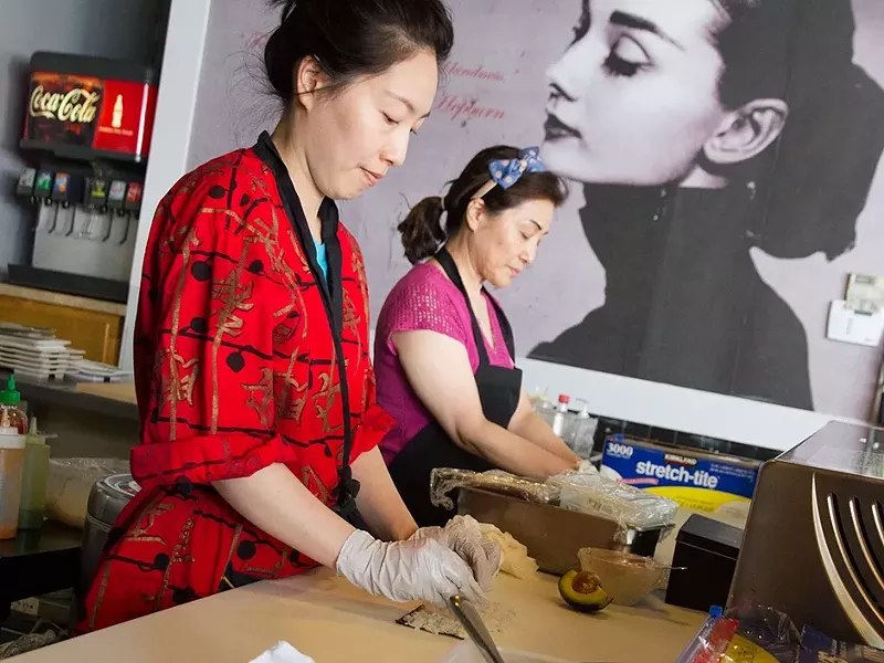 SooJi Shin, left, and her mother, Sophia Lee, roll sushi at Kinja. - JENNIFER DEBARROS