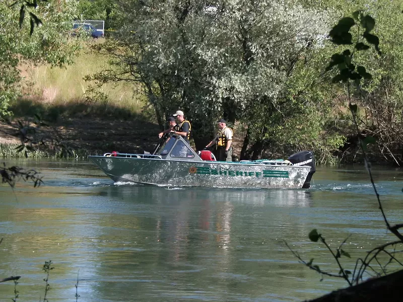 Spokane County sheriff's deputies search the Spokane River on Wednesday afternoon. - CHRIS BOVEY