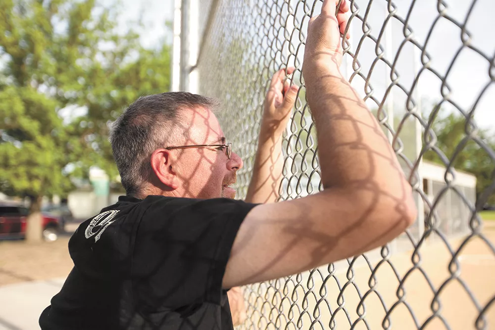 Stuart Heberlein watches his son try out for a baseball team at Chief Garry Park. Heberlein tried to resuscitate a doctor mortally wounded during the 1994 shooting. - YOUNG KWAK