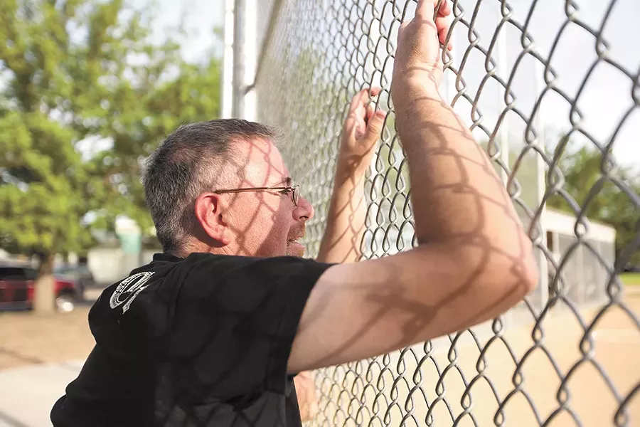 Stuart Heberlein watches his son try out for a baseball team at Chief Garry Park. Heberlein tried to resuscitate a doctor mortally wounded during the 1994 shooting. - YOUNG KWAK