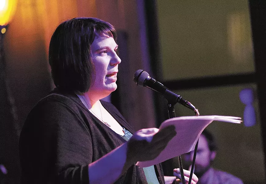 Teri Koski reads her poem "The Truce" at an open mic night. - YOUNG KWAK