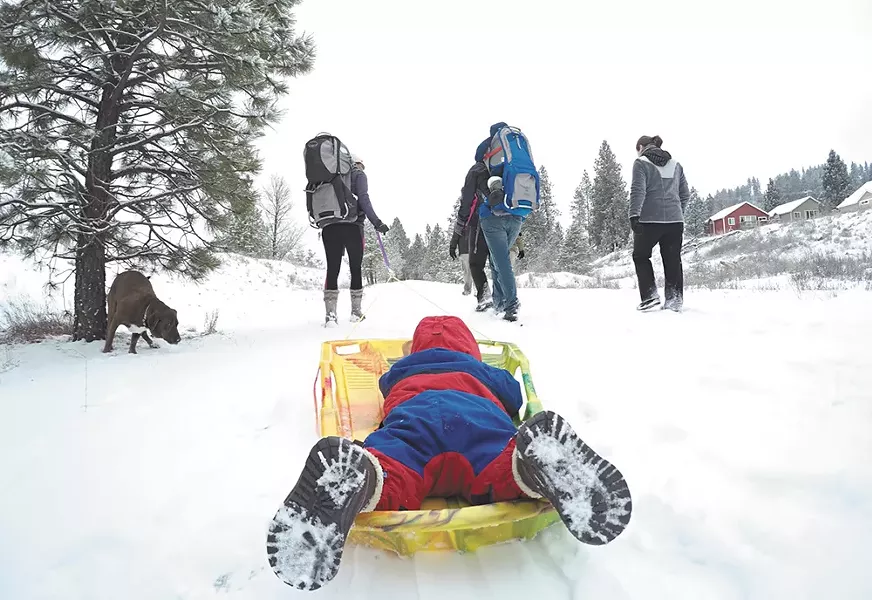 The "Hike It Baby" group gathers for a snowy walk on Spokane's Fish Lake trail. - JOE KONEK