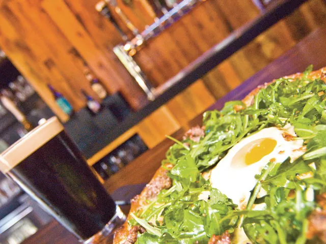 The Kiernan at the Flying Goat: Italian sausage and arugula topped with an over-medium egg. The pub has nitro tap for beers like Rogue's Shakespeare Stout. - TAMMY MARSHALL