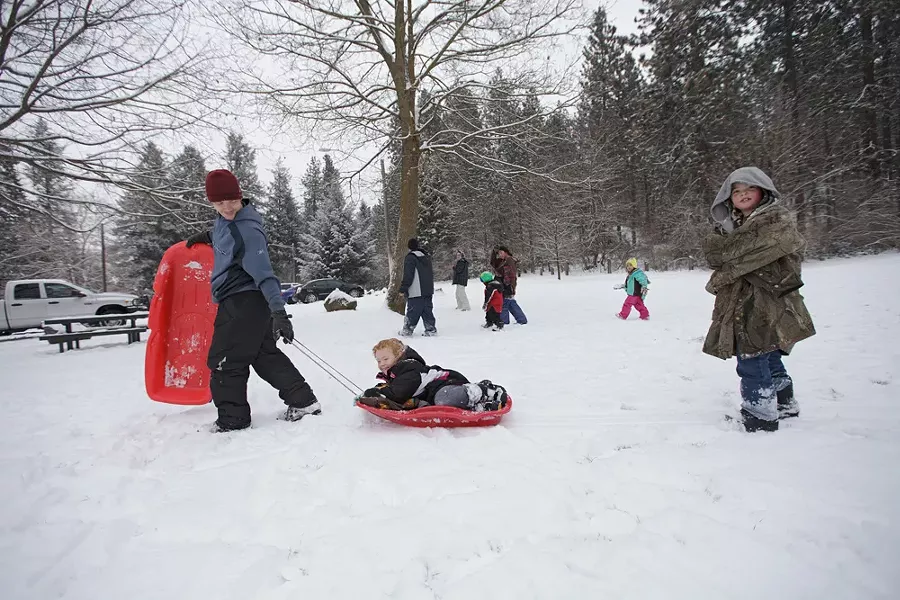 Thomas Bakken, left, pulls his daughter on a sled as his son follows. - YOUNG KWAK
