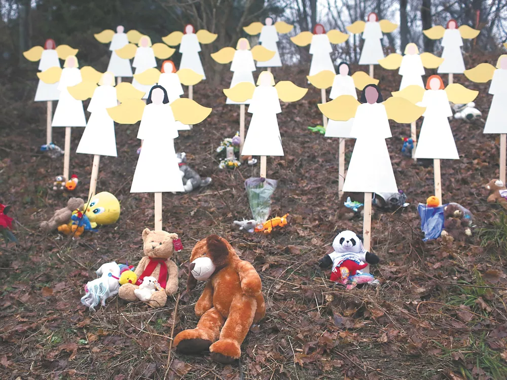 Twenty-seven wooden angels stand in a yard down the street from the Sandy Hook School in Newtown. - SPENCER PLATT | GETTY IMAGES
