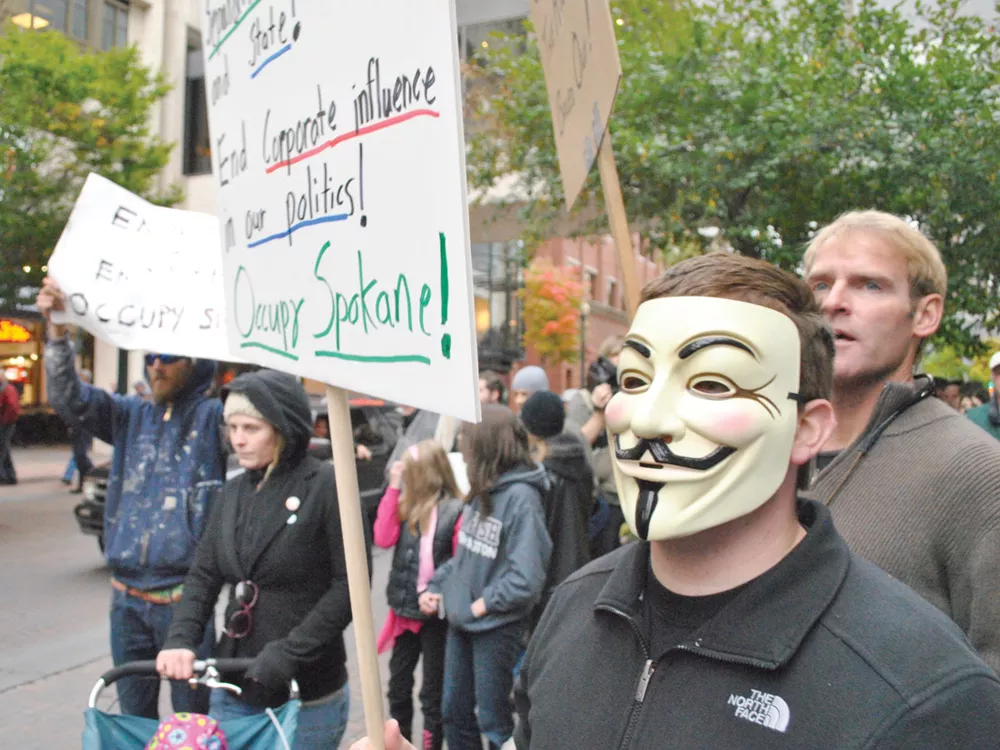 Two marches over the weekend brought hundreds out in the streets, including some sporting Guy Fawkes masks. - CHRIS STEIN