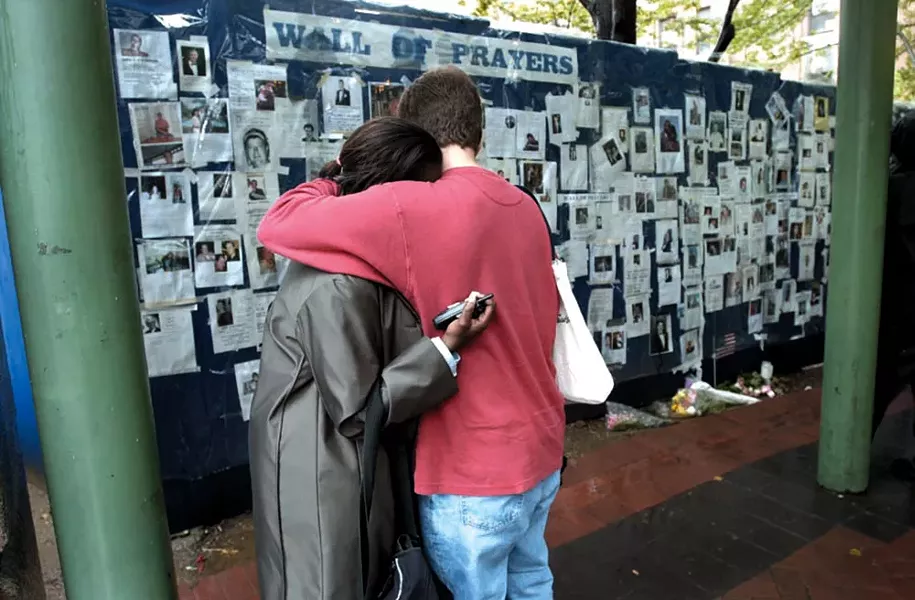 Two New Yorkers at the wall of prayers after 9/11.