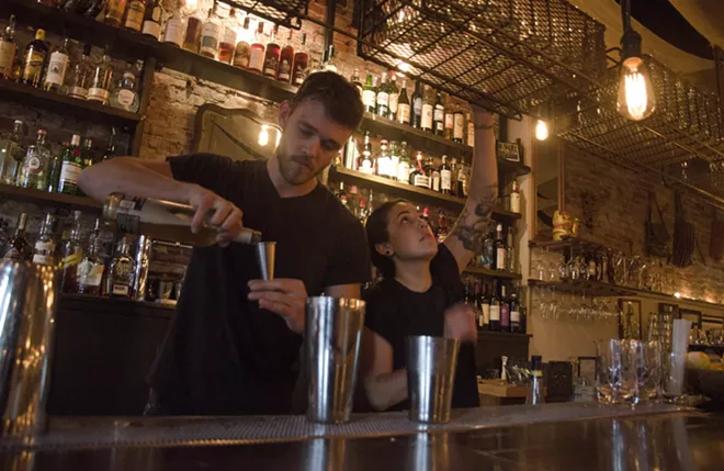 Bartenders Lars Lunstrom and Ariana Barela mix drinks on a recent Thursday evening at the Black Cypress. - JACOB JONES PHOTO