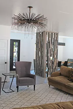 The dazzling living room light fixture was purchased on personal shopping trip to Denver; Lisa designed and crafted the mid-century modern wood screen from scrap lumber on the homebuild site. - YOUNG KWAK