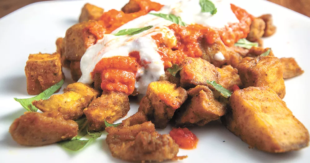 Homemade harissa and ras el hanout spices make this eggplant dish; cooking five minutes too long ruins it. - DANIEL WALTERS PHOTO