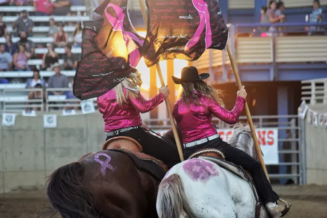 The Spokane County Interstate Fair Flag Team circles the arena in support of breast cancer survivors. - QUINN WELSCH PHOTO