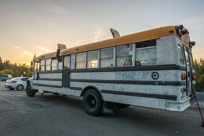 A school bus retrofitted in Grateful Dead-fan style parks at People's Park in Spokane. Eventually, the bus is headed for the Okanogan Family Faire. - DANIEL WALTERS PHOTO